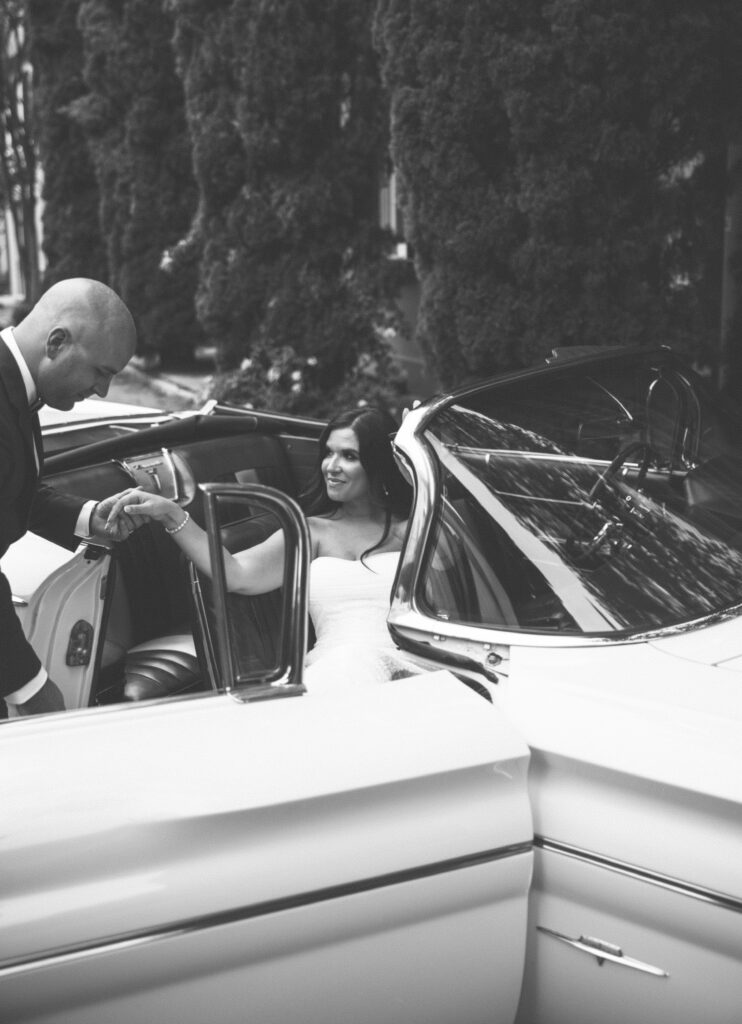Couple portraits with the classic car this bride and groom rented for their Charleston, SC wedding.