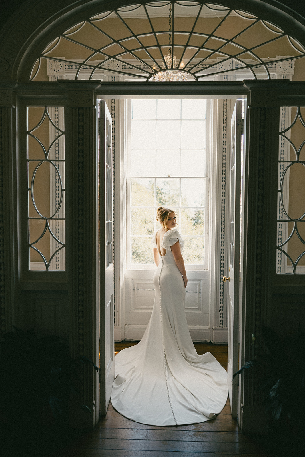 A bride poses in her getting ready suite before her wedding ceremony.