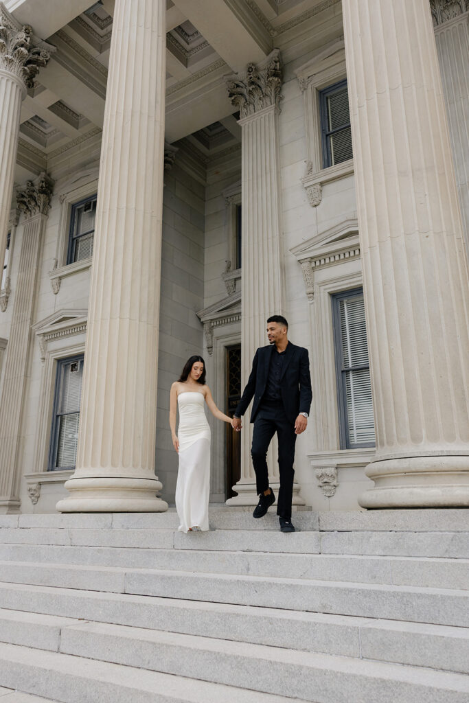 Engagement photos along King Street's storefronts in downtown Charleston