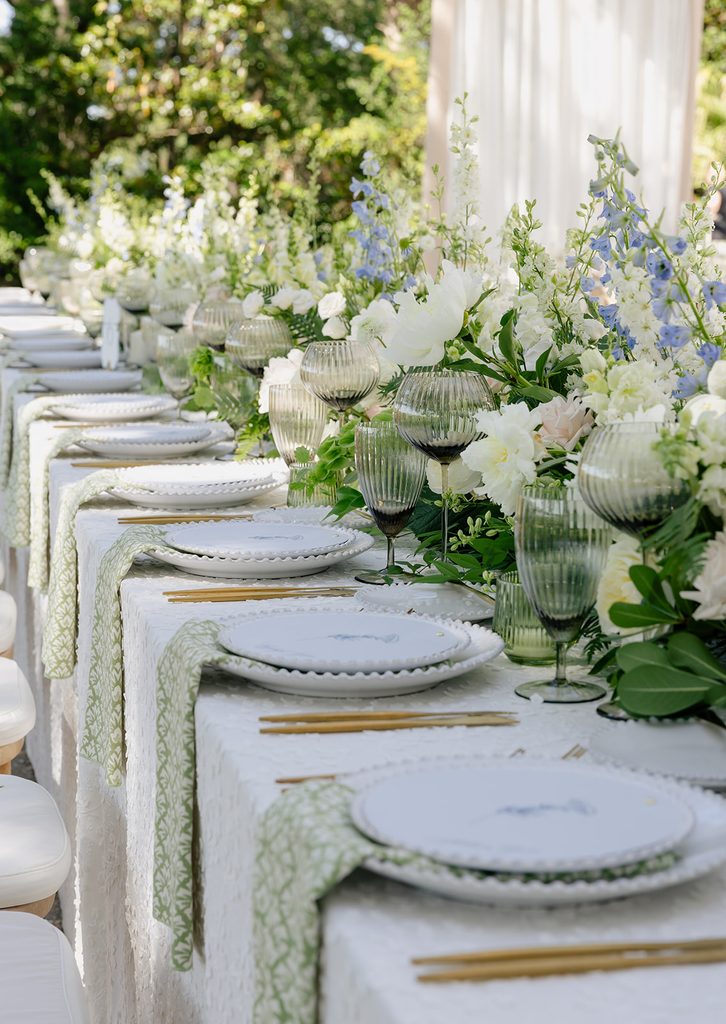 Long reception table with white florals and green linens at a Lowndes Grove wedding in Charleston